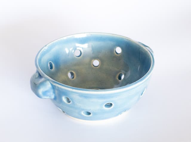 Blue ceramic colander