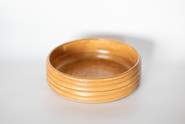 Yellow glazed bowl with ribbed texture